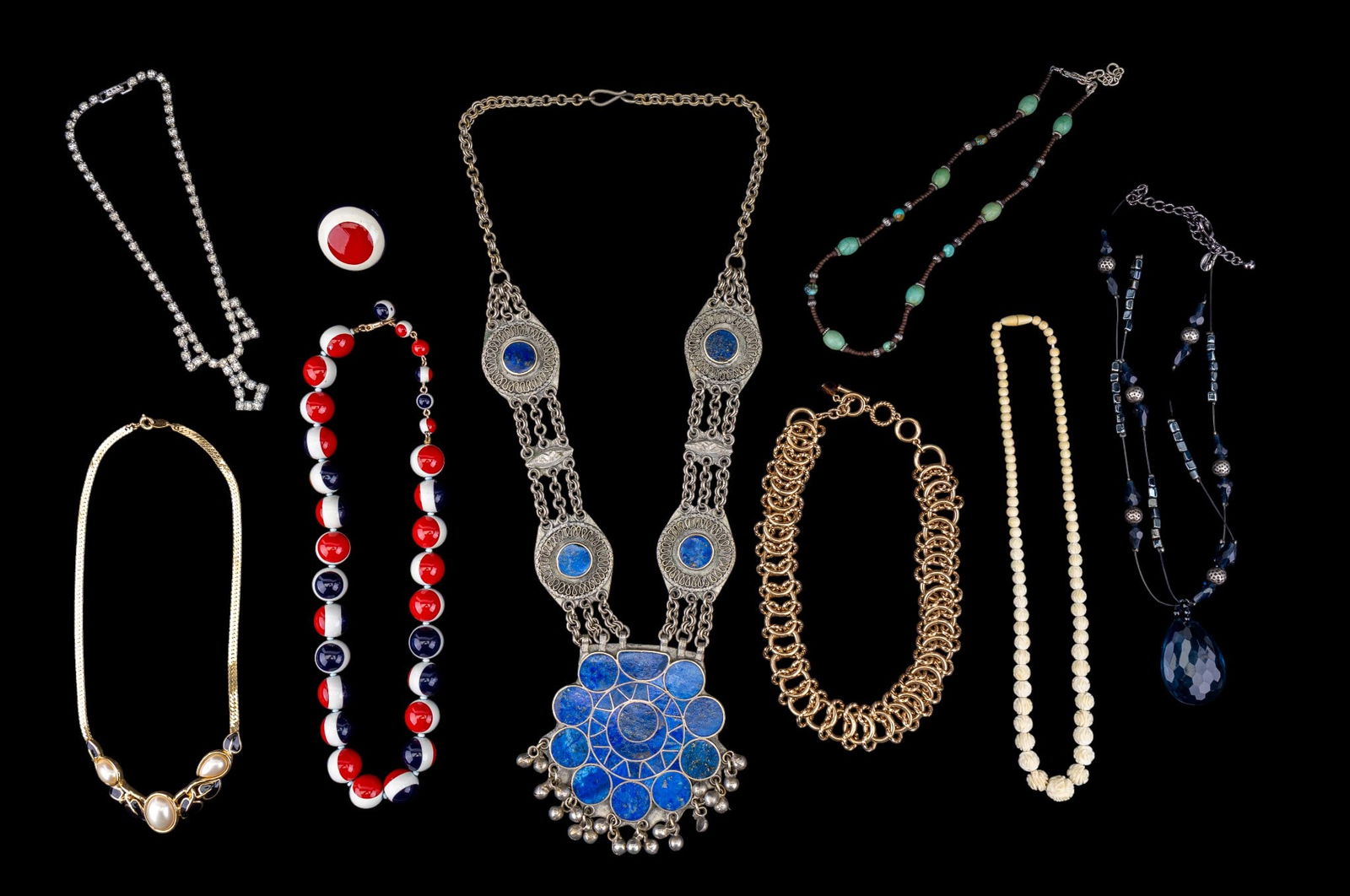 Afghan Tribal Necklace and Other Estate Necklaces: A collection of estate necklaces including an Afghan tribal statement necklace featuring lapis lazuli inlay, a carved natural material graduated rosette bead necklace, a gold tone and faux pearl colla