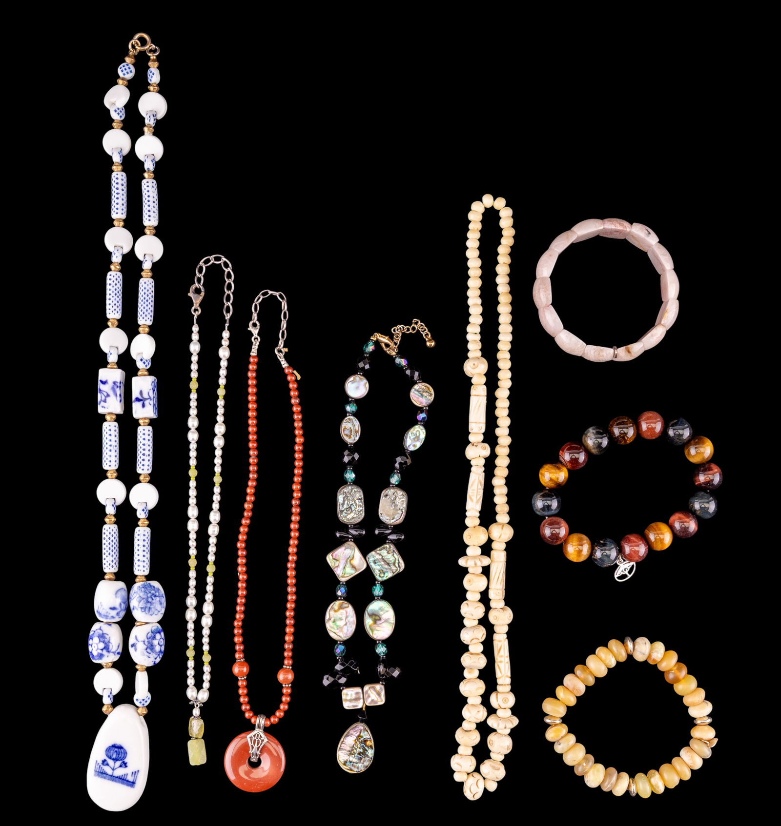 Porcelain, Carved, & Stone Jewelry: Includes a blue and white porcelain painted necklace, tiger's eye bracelet with sterling tag, a carved bone necklace, and more.