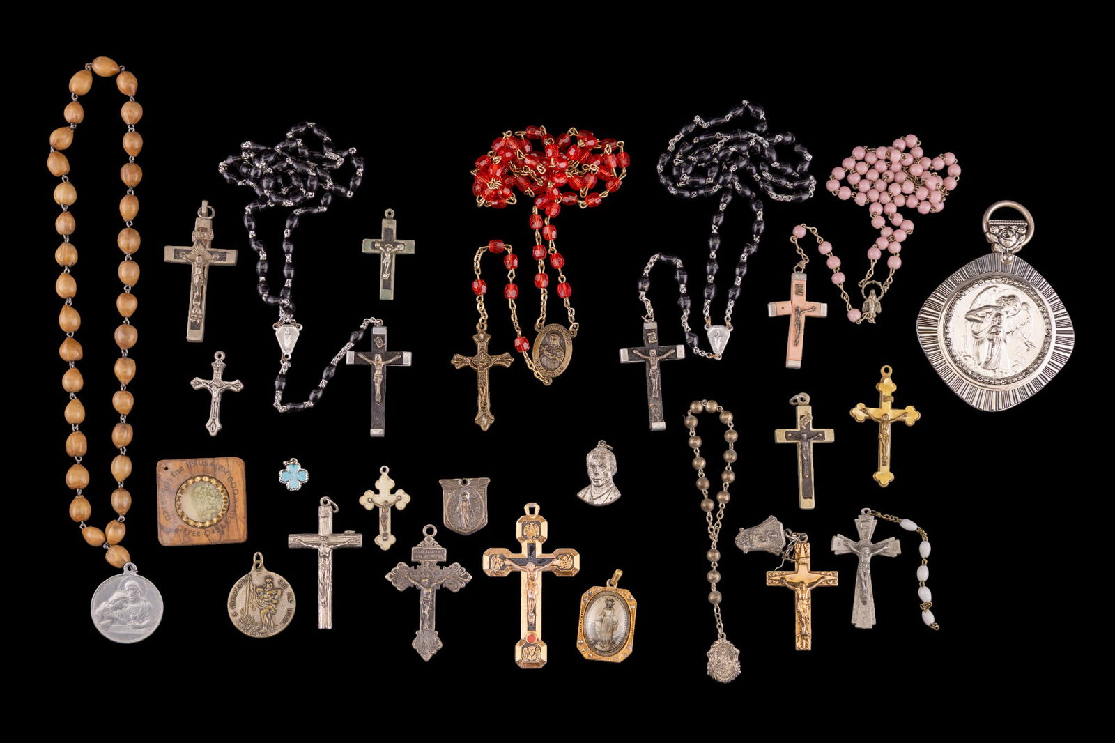 Rosaries, Cross Pendants, and Religious Medallions: A collection of vintage Rosaries, Cross and Crucifix pendants, prayer medallions, a souvenir of olive wood and copper ore from Jerusalem.