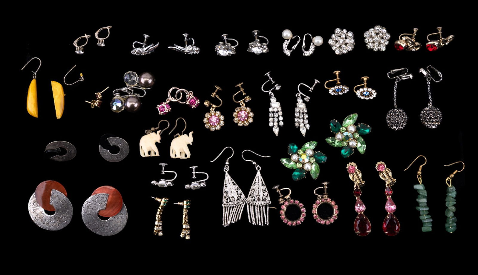 Vintage Rhinestone and Other Earrings (24prs): A collection of 24 pairs of vintage clip on, screw back, and pierced earrings including rhinestones, a pair of French hook earrings featuring jade stone beads, etched stud earrings, and more.