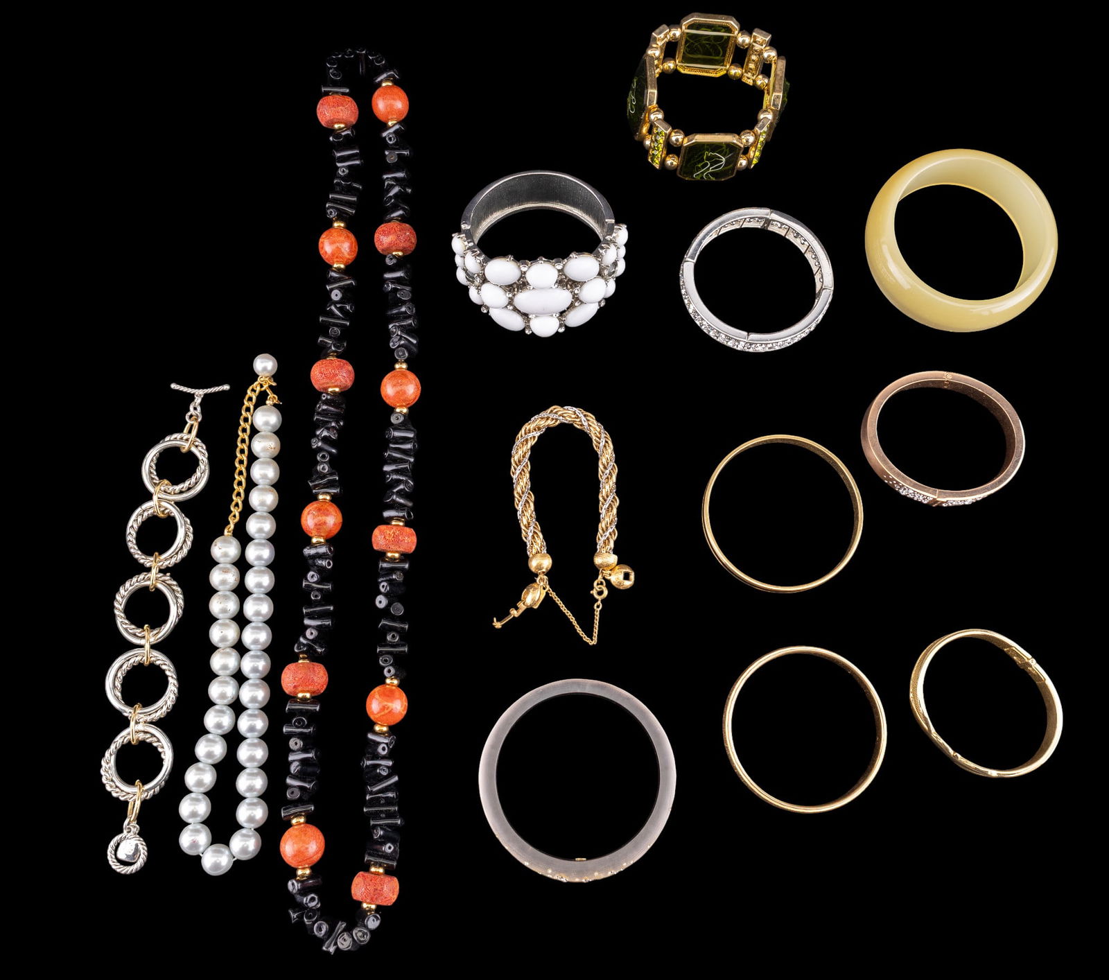 Costume Designer Bracelets: A collection of costume designer bracelets including cuffs, bangles, and twisted gold tone rope bracelets by Monet, a toggle bracelet by Ralph Lauren, a rose gold tone and rhinestone hinged cuff by Mi