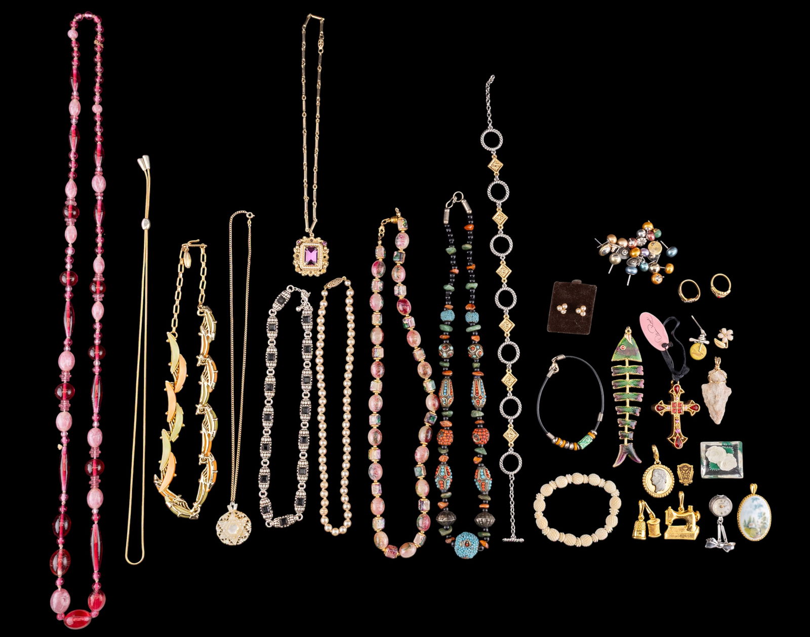 Vintage Estate Jewelry: A collection of vintage estate jewelry including an opera length pink glass bead flapper necklace, a carved stone arrowhead souvenir pendant, an Imperial skeleton watch brooch, a porcelain Kaiser Germ