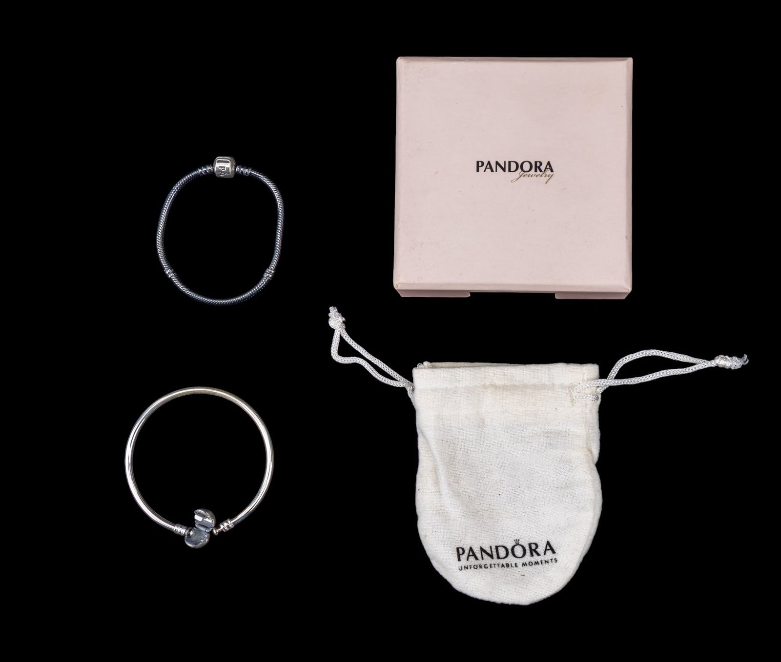 Pandora 925 Charm Bracelet Snake Chain and Bangle: Two sterling silver Pandora charm bracelet frames including a dark tone snake chain and a silver bangle frame. Approx. weight of sterling: 21g. Includes Pandora box and felt jewelry bag.