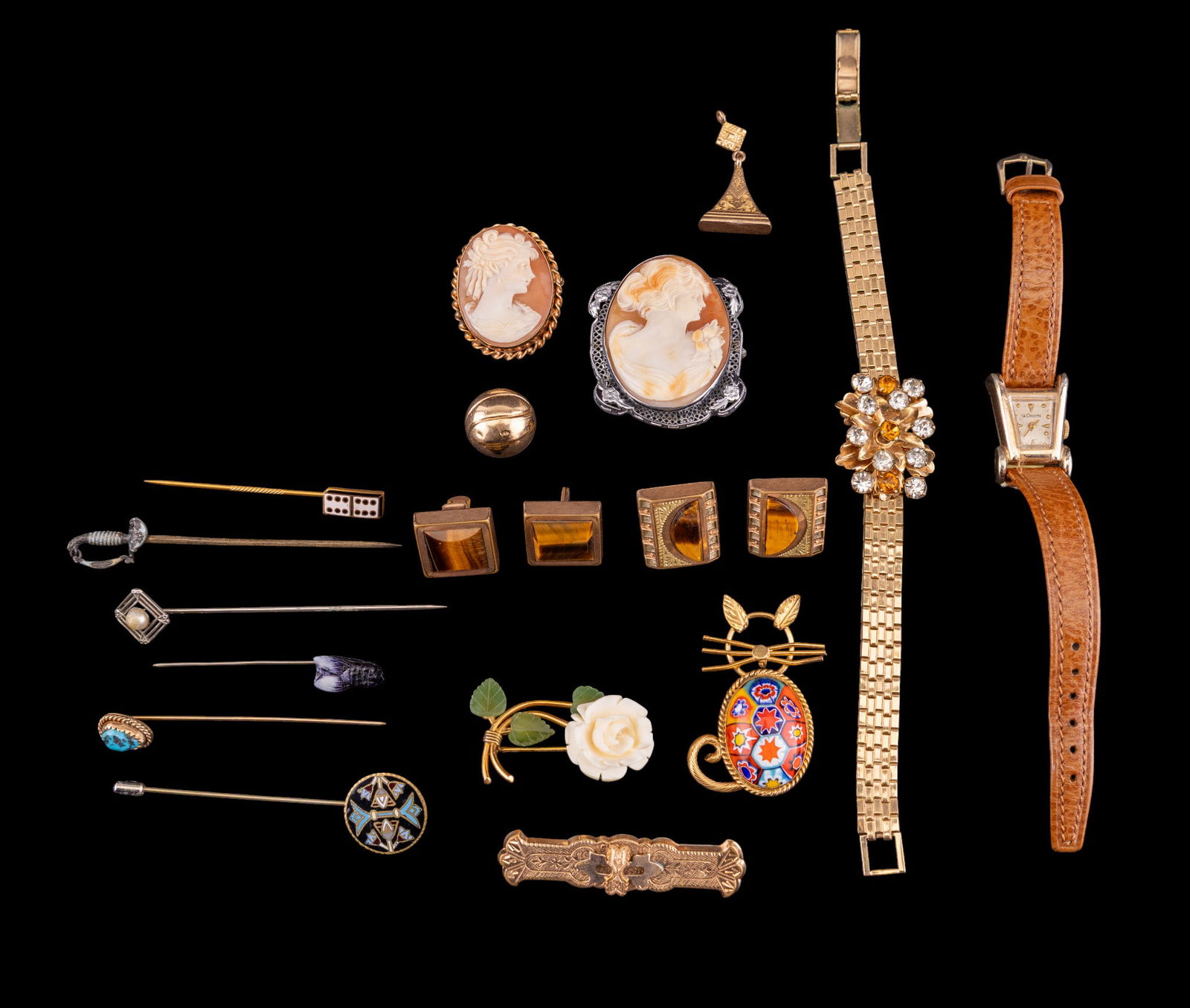 Victorian Gold Filled and Cameo Jewelry and Watch: A collection of Victorian gold filled jewelry including stick pins, one with sterling top, a watch fob, a floral rhinestone bracelet, a carved natural material rose and jade leaf brooch, a miliefiori