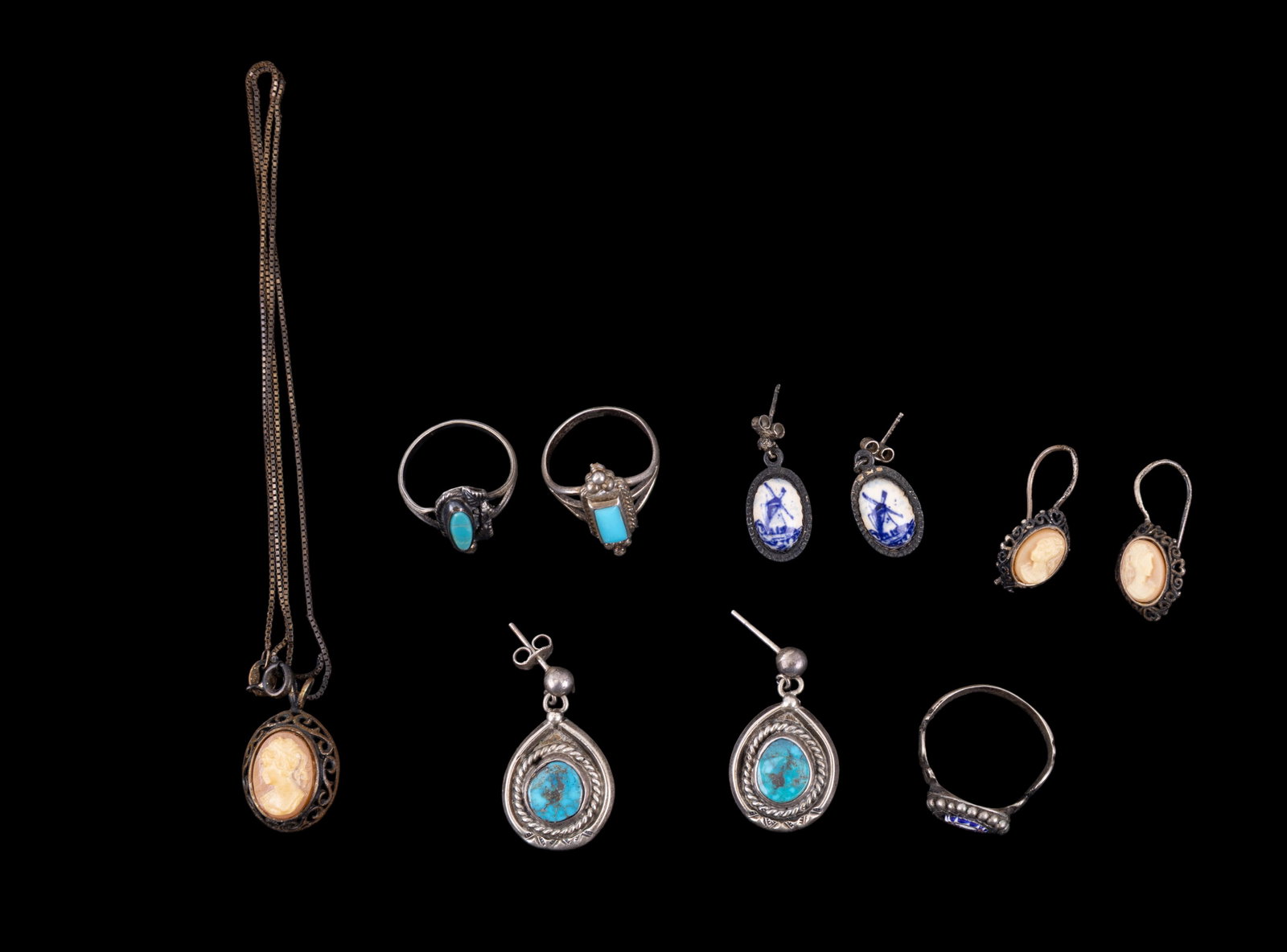 Vintage and Native American Silver Jewelry: A collection of vintage jewelry featuring unmarked silver and turquoise Native American dangle earrings, a pair of unmarked Delft porcelain and silver earrings, vintage sterling silver cameo drop earr