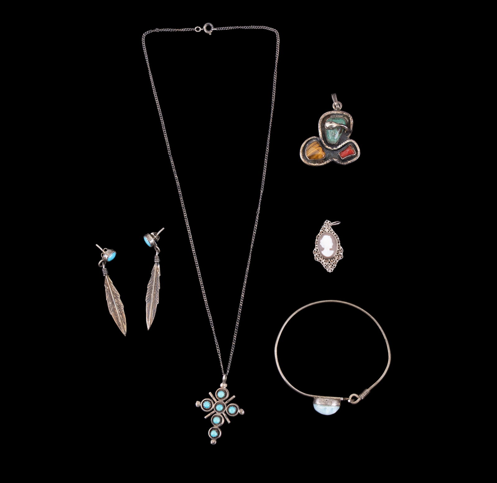 Native American and Other Silver Jewelry: A collection of Native American and other silver jewlery including an early filigree framed cameo pendant, a pair of unmarked turquoise and silver stud feather earrings, an unmarked silver cuff bracel