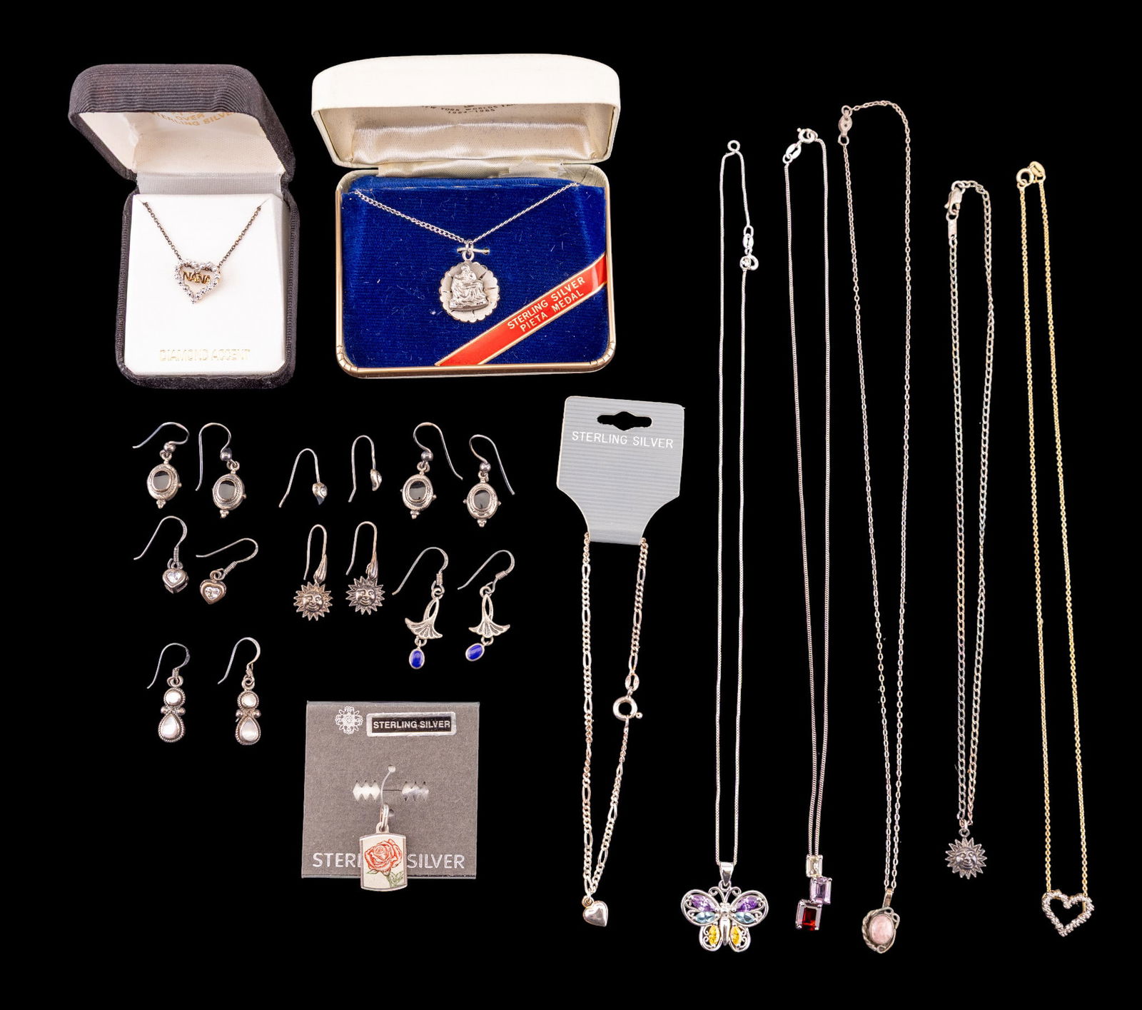 Sterling Silver Earrings and More: A collection of sterling silver jewelry including 9 pairs of French hook drop earrings featuring mother of pearl, lapis lazuli, onyx, and rhinestones, a sterling Figaro chain bracelet with heart charm