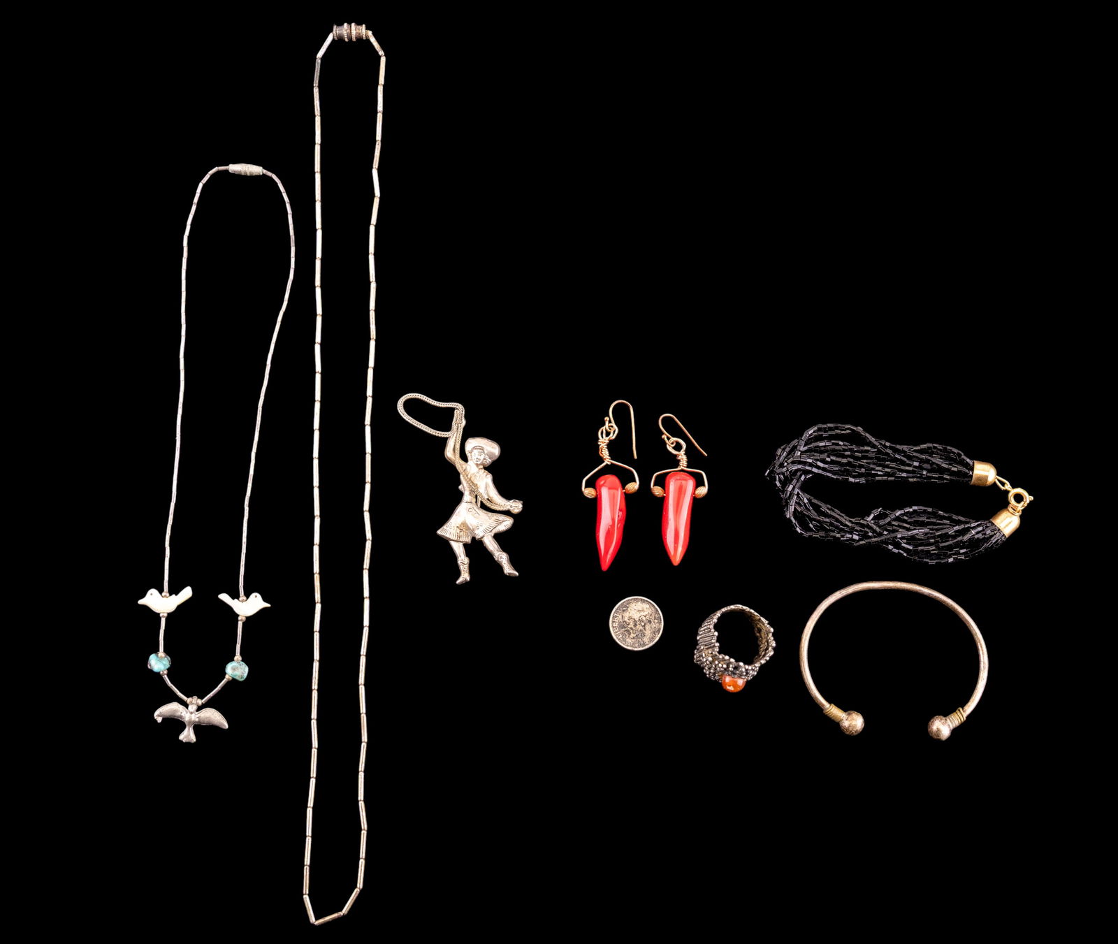 Silver, Coral, Native Jewelry & Coin: Jewelry lot includes a tested silver ring (unmarked, testing 800 purity, 11.11g); a sterling silver brooch featuring a cowgirl with lasso (marked, 5.36g); a bangle bracelet marked 925 (10.55g); a ston