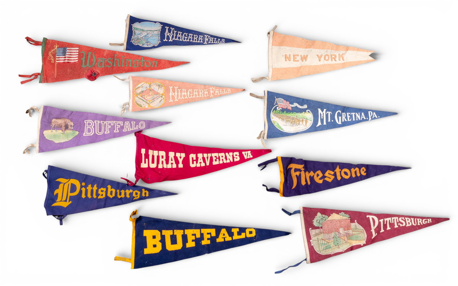 Early 20th C Souvenir Pennants (11): A collection of 11 early 20th C souvenir pennants featuring a Firestone advertising pennant, Niagara Falls, Buffalo, Pittsburg, New York City, Lurray Caverns, Washington D.C., and Mt. Gretna, PA.