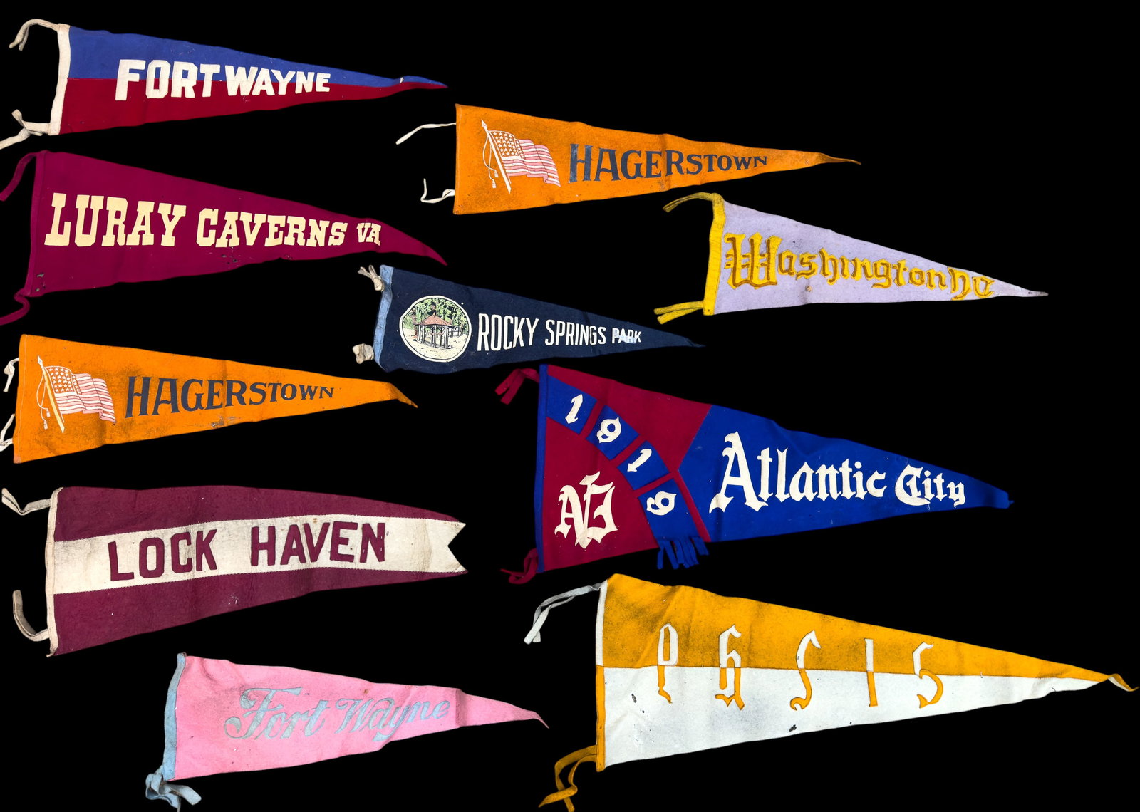Early 20th C Souvenir Pennants (10): A collection of 10 early 20th C souvenir pennants featuring a Firestone advertising pennant, Lurray Caverns, Rocky Springs Park, Hagerstown, Fort Wayne, Washington D.C., Lock Haven, and Atlantic