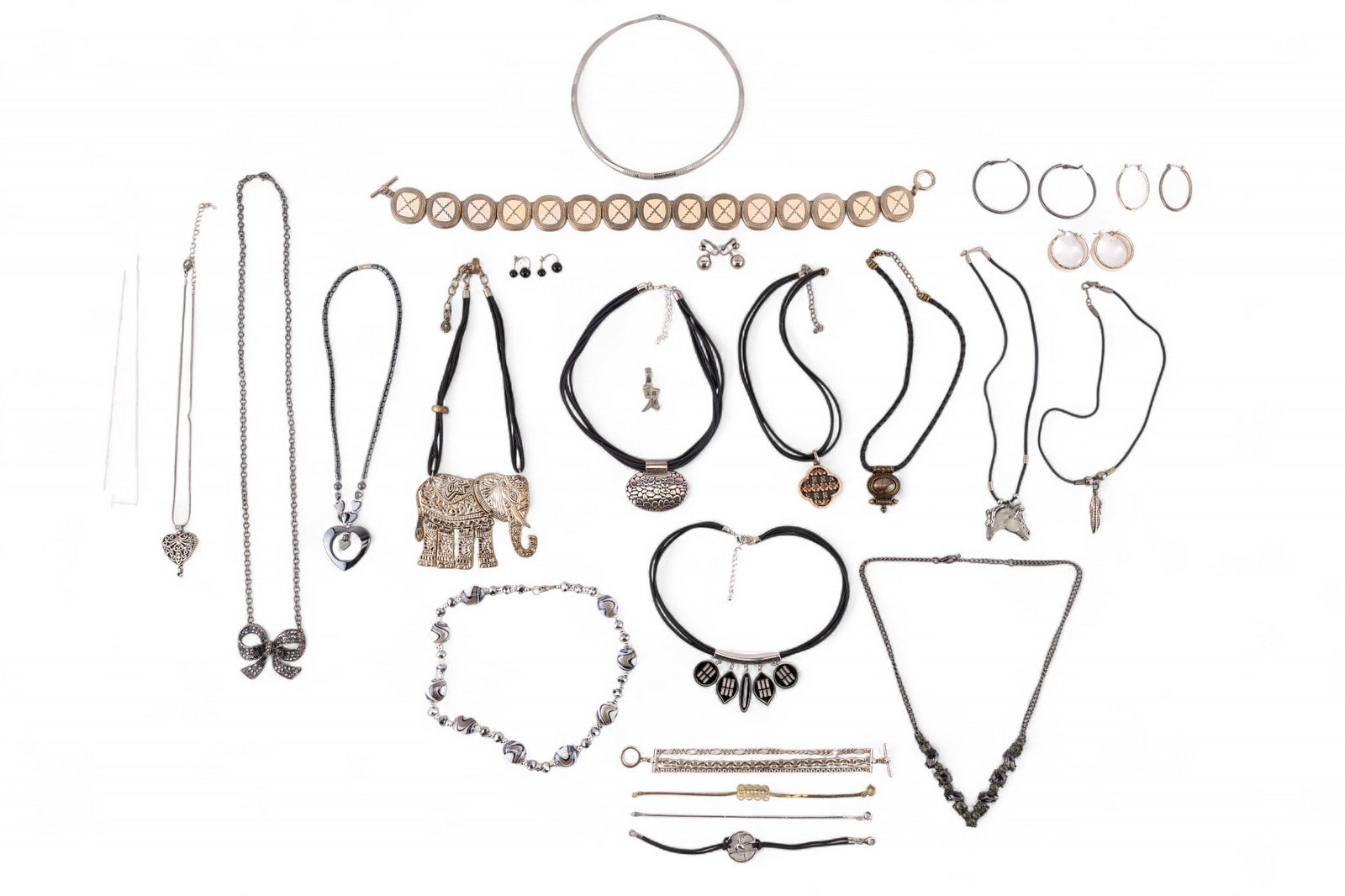 Silver Tone Costume Jewelry: Large grouping of silver tone costume jewelry including Chaps hoop earrings, Marimo silver tone clip earrings, rhinestone necklaces, figural necklaces with elephant, horse and more.