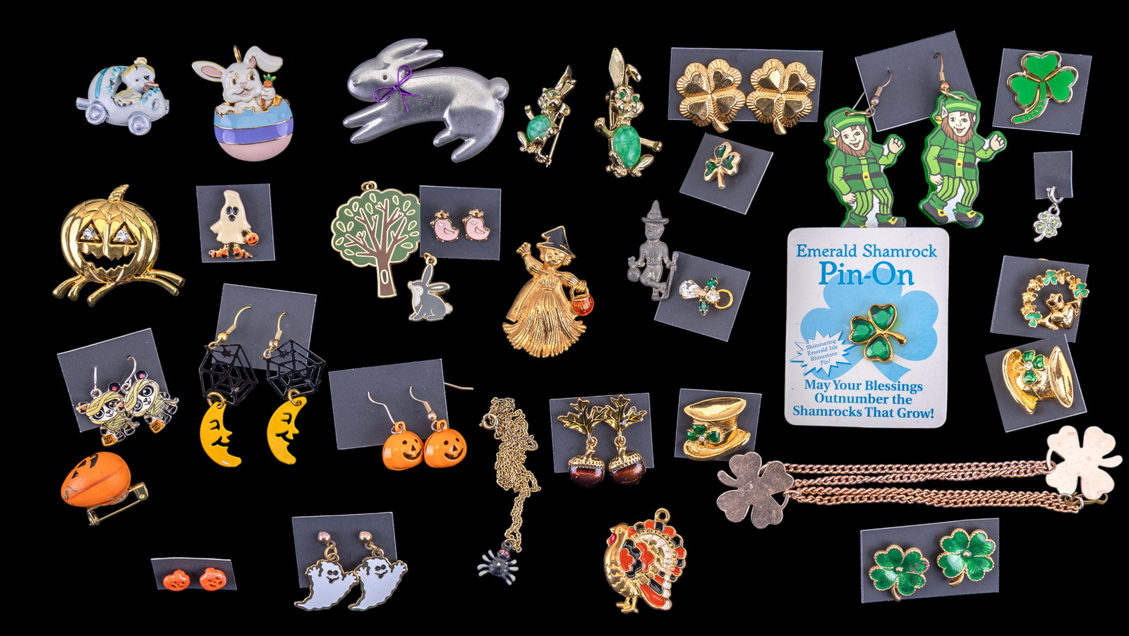 Holiday Jewelry: 34 pieces of jewelry representing St. Patrick's Day, Easter, Halloween, and Thanksgiving. Earrings, pins, charms, bracelets, and necklaces. A pair of Avon acorn earrings.