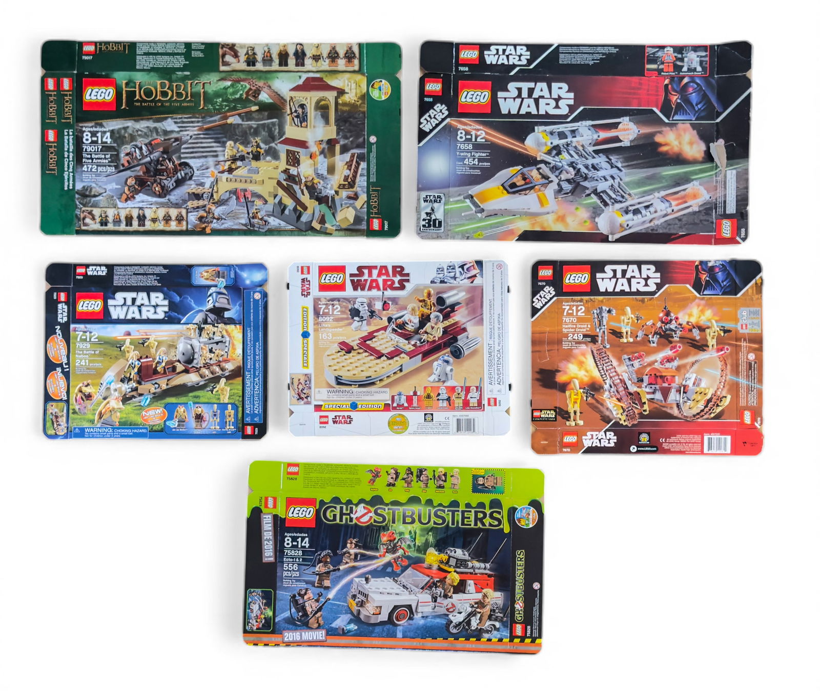 Flattened LEGO Boxes: Includes six flattened LEGO set boxes: 'The Hobbit: The Battle of Five Armies' (79017), 'Star Wars: Desert Skiff' (9496), 'Star Wars: AT-RT Battle' (75002), 'Star Wars: Y-Wing Fighter' (7658), 'Star