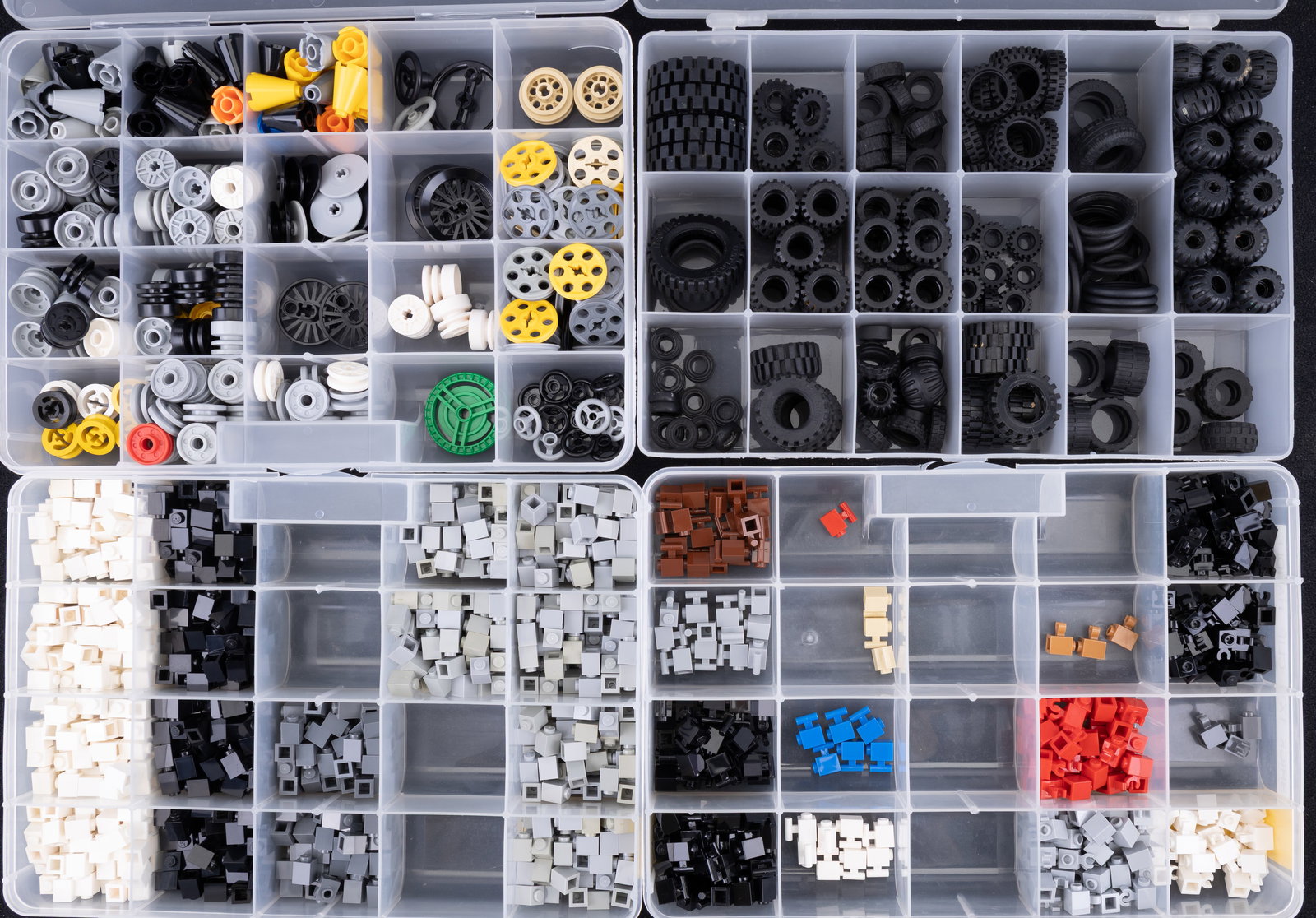 Four Containers of Assorted LEGO Parts: Four plastic containers with compartmentalized sections, filled with assorted LEGO pieces. Components include specialized pieces such as 'Battle Droid Parts,' various building elements in different co