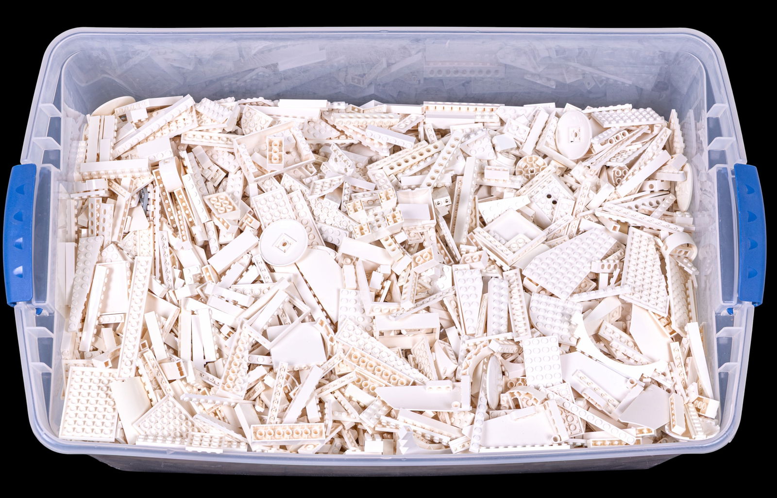 30 Pounds of White LEGO Pieces: A large quantity of approximately 30 pounds of white LEGO pieces stored in a plastic container. The collection includes a variety of bricks, plates, and structural elements suitable for building proje