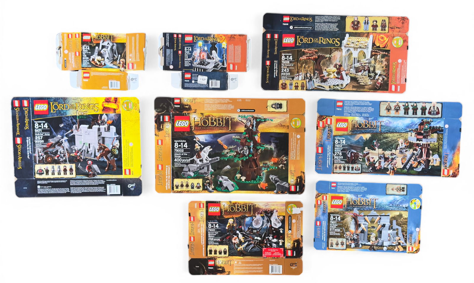 Flattened LEGO Boxes, Lord of the Rings & Hobbit: Seven flattened LEGO set boxes including sets 79001, 79010, 79003, 79006, 9471, 79002, and 79004 from The Hobbit and The Lord of the Rings series. No LEGO pieces are included.