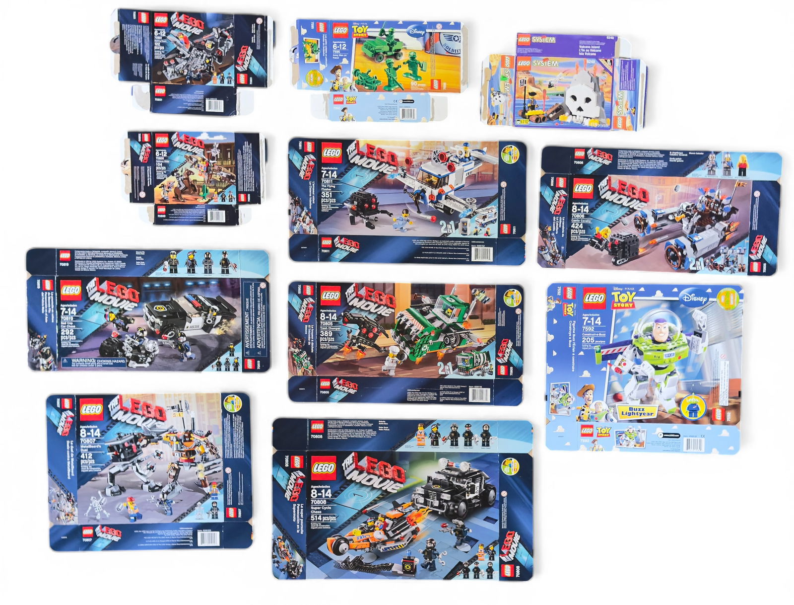 Flattened LEGO Set Boxes: 11 flattened and empty LEGO set boxes, including themes such as The LEGO Movie, LEGO Toy Story, and LEGO System. Boxes range in piece counts from 90 to 514 as indicated on their fronts. Examples inclu