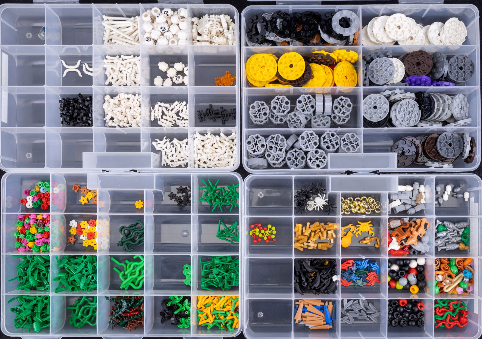 Four Containers of Assorted LEGO Parts: Four plastic containers labeled with assorted LEGO parts, including skeleton parts, flowers, vines, plant bases, food pieces, rings, animals, and 4?4 round plates. Each compartment is organized and se