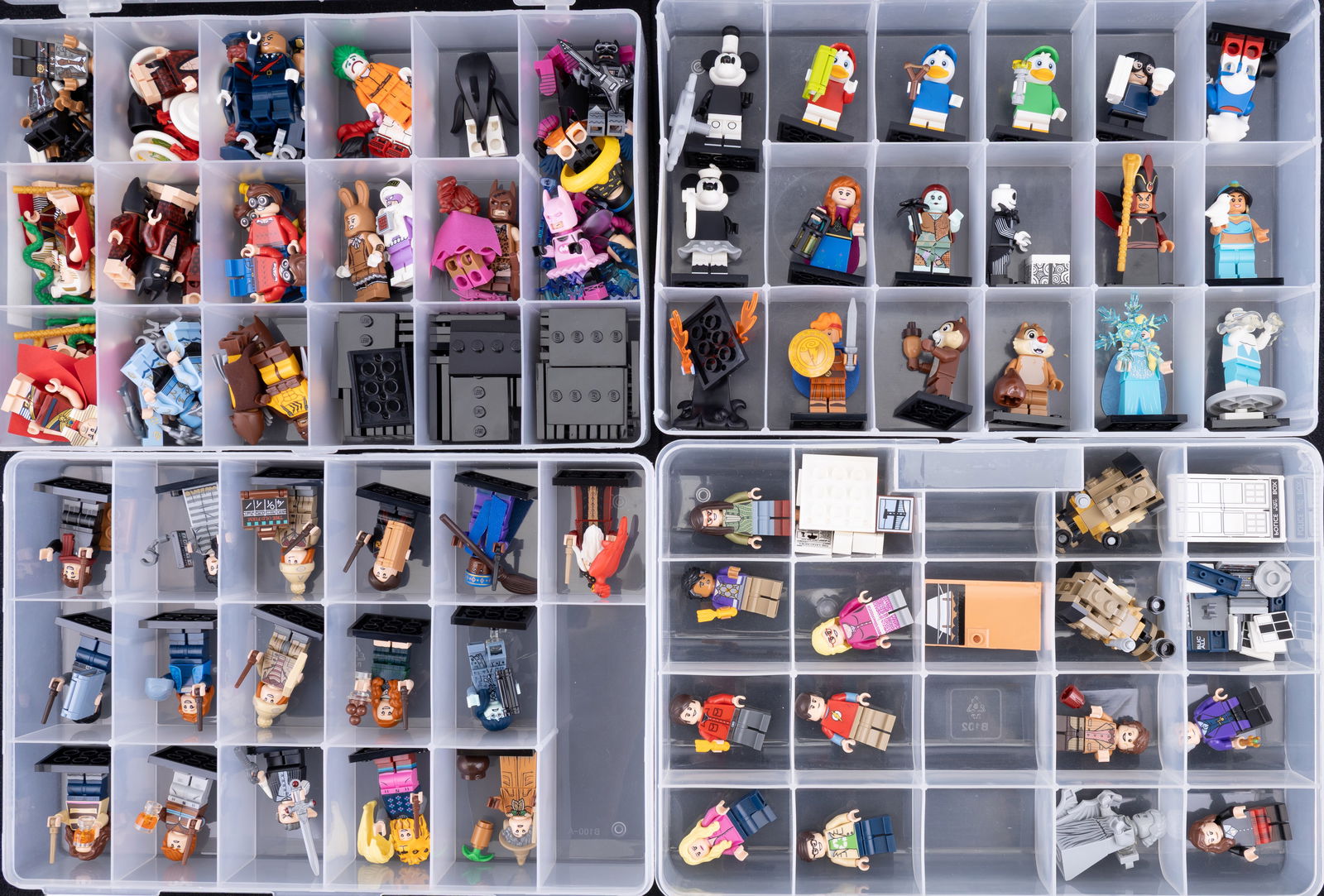 Four Containers of Assorted LEGO Minifigures: Four plastic containers filled with assorted LEGO minifigures and accessories. Includes characters from themes such as Harry Potter and others, with visible variety in torsos, heads, and accessories.