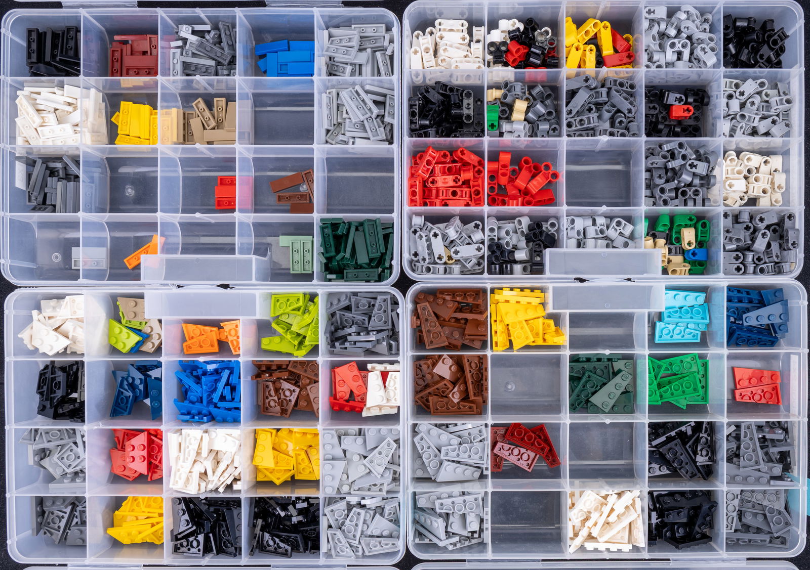 LEGO Plates, Tiles, & Technic Pieces in Organizers: LEGO parts organized into multiple compartmentalized storage boxes. Includes Plate Wedge 2?3, Double Wedge 2?4, Tile 1?3, and Technic Axle Connectors in various colors and quantities. Each type is lab