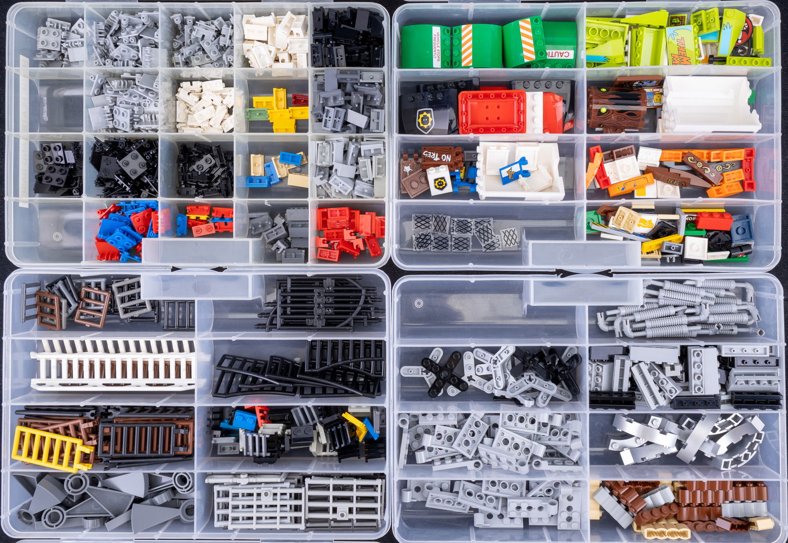 Lego Brick and Component Collection: Organized collection of Lego components in labeled storage boxes. Categories include 'Ladders, Gates, Stairs,' featuring structural elements; 'Hinge Plates and Bases,' containing jointed pieces; and '