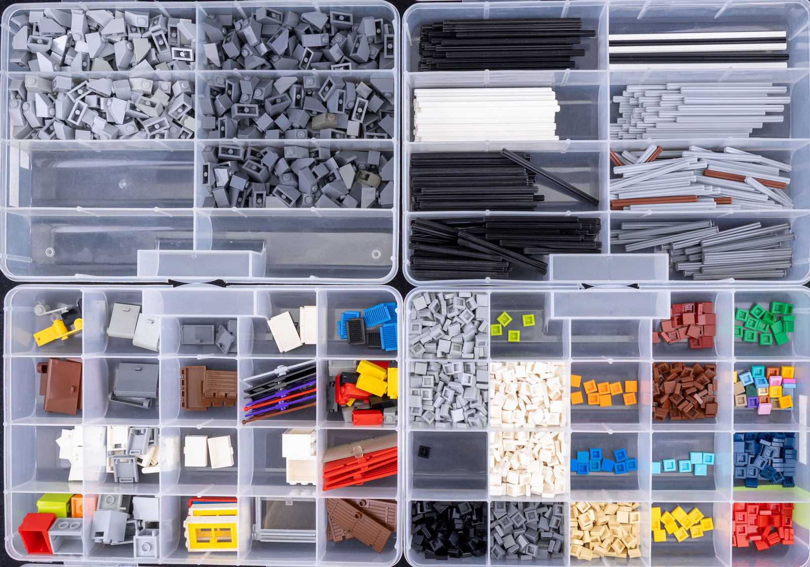 Organized Lego Technic and Standard Parts Set: Lego Technic and standard pieces stored in labeled plastic compartments. Includes long Technic axles, gray slope bricks, 1?1 tiles in various colors, and Lego doors and cabinet pieces.