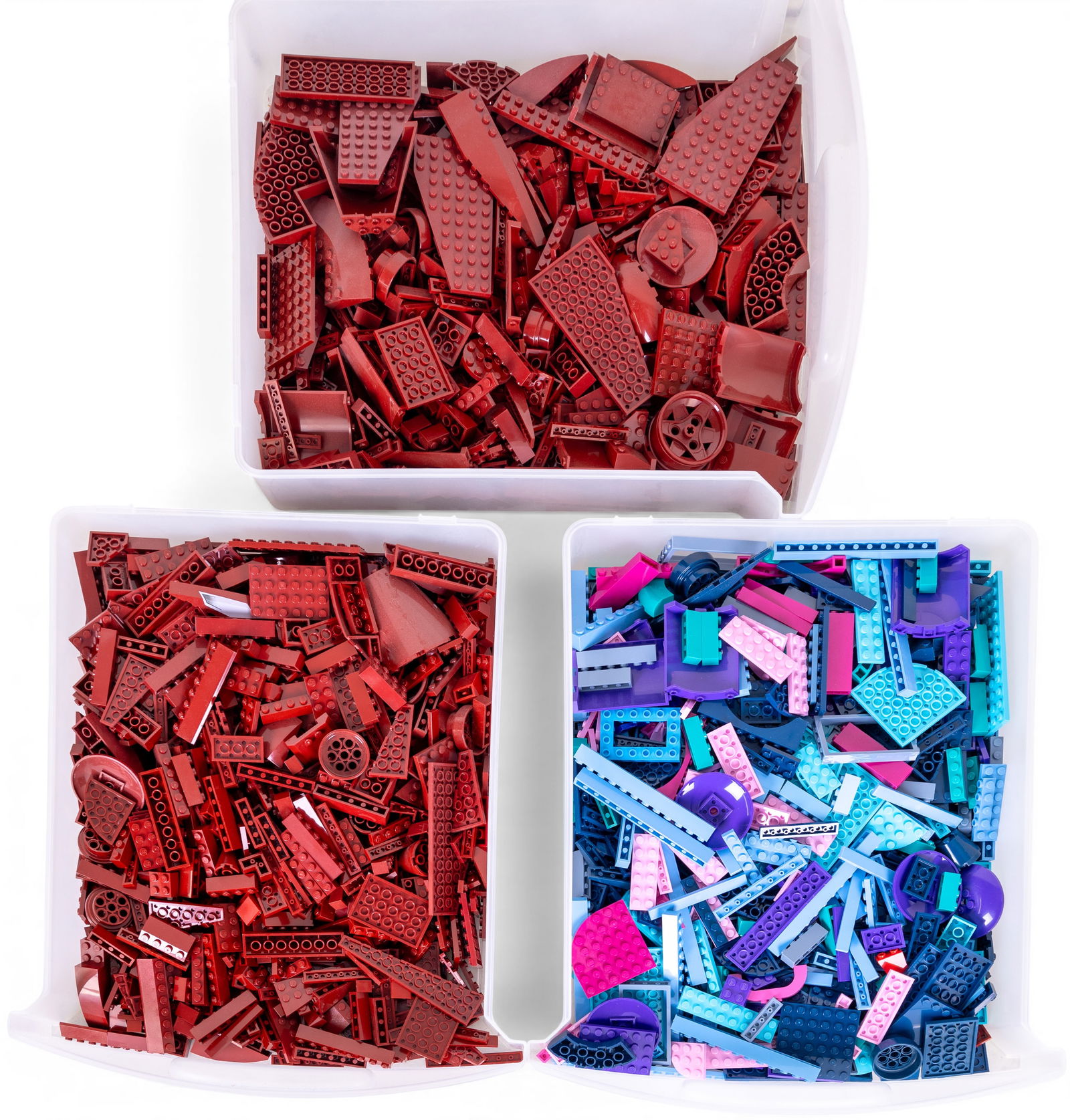 Lego Pieces, Approximately 10 lbs: Lego pieces in various shapes, sizes, and colors. Includes predominantly red bricks and panels, along with multicolored pieces such as purple, teal, and pink. Components vary in type, including plates