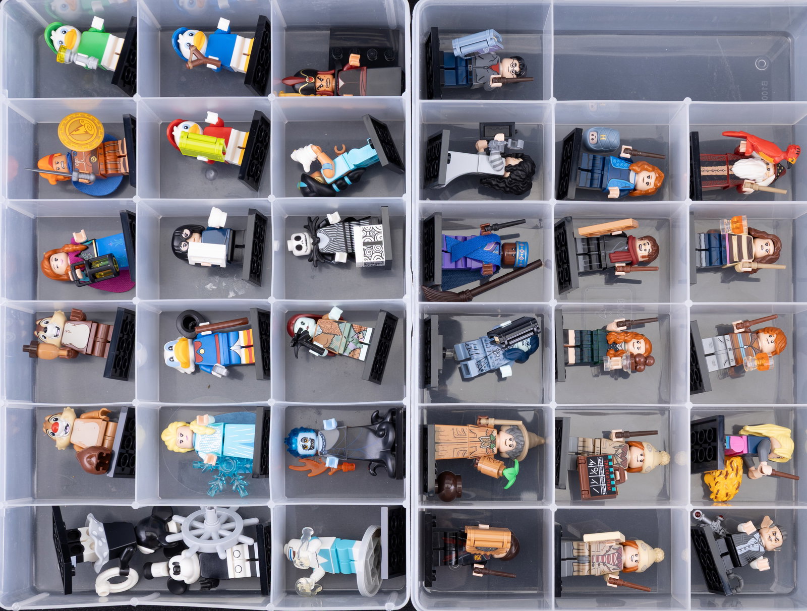 Lego Minifigures in Organized Containers: Two storage containers of Lego minifigures, each with individual compartments. The first container appears to feature a complete set of Disney Series 2 minifigures. The second includes a variety of Ha