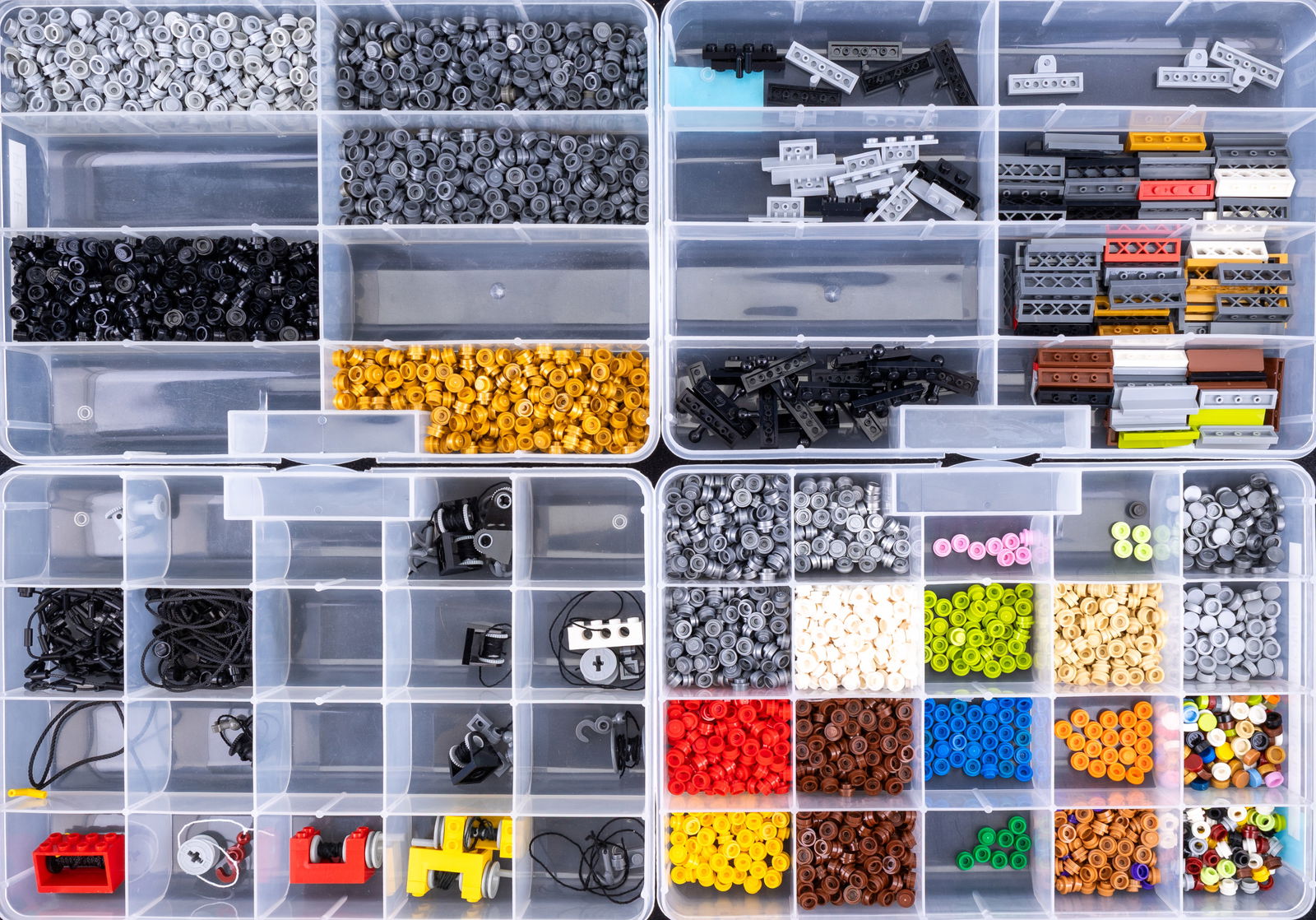 Four Containers of Sorted LEGO Pieces: +4 Four Containers of Sorted LEGO Pieces Four containers of LEGO parts meticulously sorted into labeled compartments. Includes 'plate 1?1 round,' 'plate 1?4 modified,' and 'winches & string,' among ot