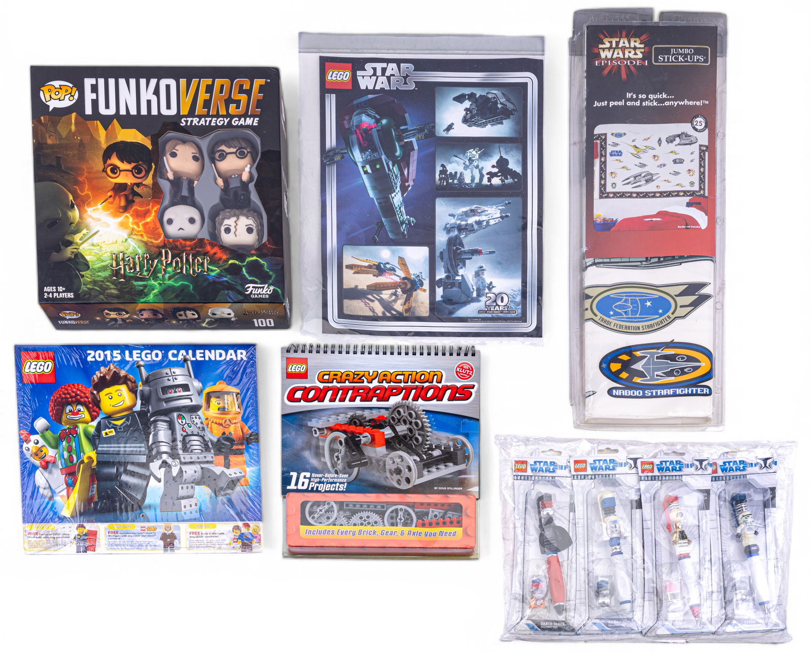 LEGO and Collectible-Themed Items: A variety of collectible items: LEGO Star Wars pens (sealed packaging), a 2015 LEGO minifigure-themed calendar (sealed), a LEGO Star Wars 20th Anniversary-themed promotional poster, approx. 10?? W x 1