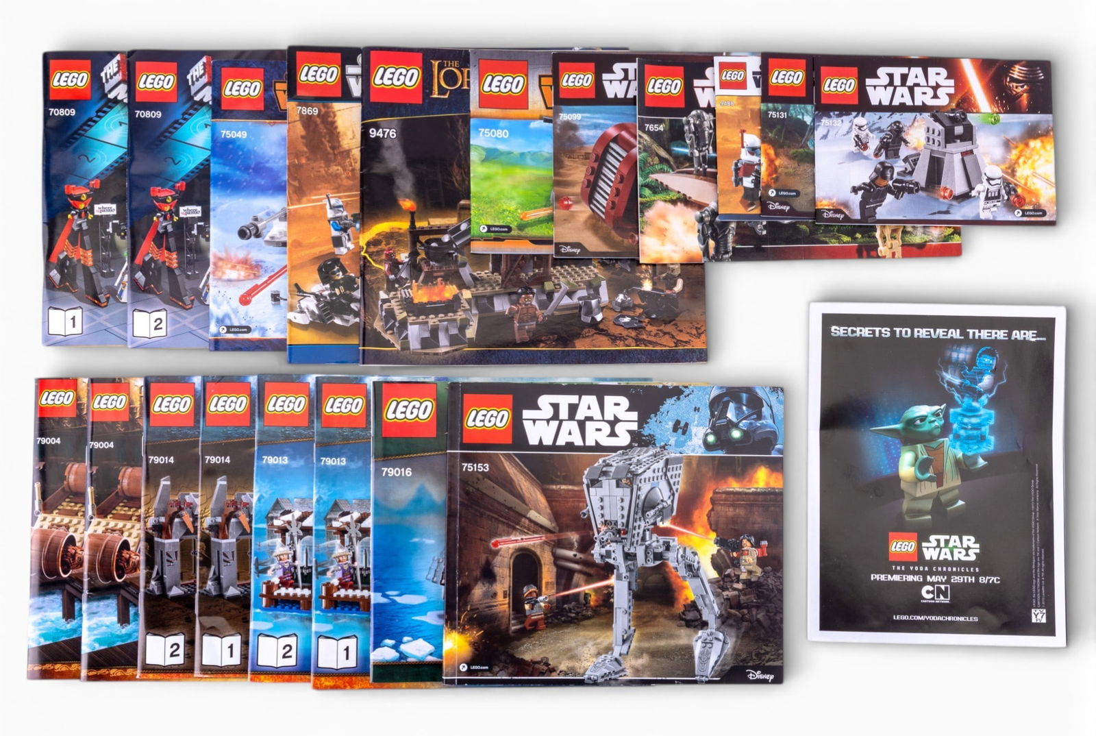 LEGO Instruction Booklets + Yoda Poster: LEGO instruction booklets featuring themes from The Hobbit, Star Wars, and others, along with a LEGO Star Wars The Yoda Chronicles poster measuring 24" x 32". Includes multiple booklets labeled by set