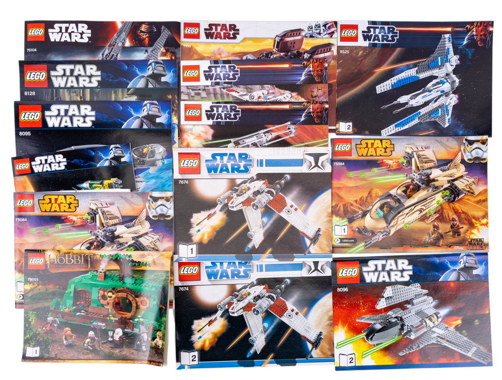 LEGO Instruction Booklets: LEGO instruction booklets, including sets from Star Wars and The Hobbit themes. The booklets feature multiple models such as starfighters, vehicles, and structures. Visible booklets include set number