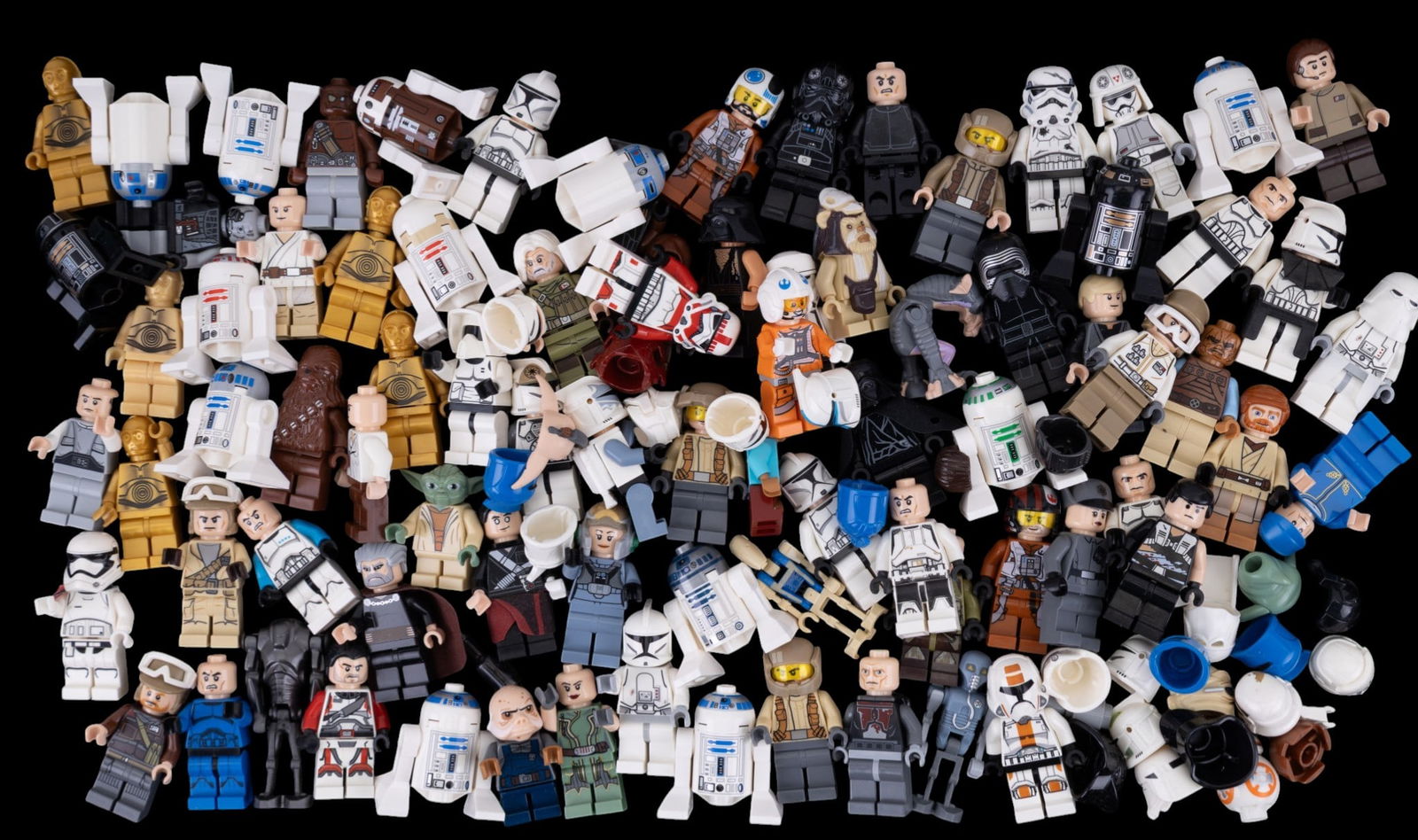 Star Wars-Themed LEGO Minifigures: Star Wars-themed LEGO minifigure parts and accessories housed in a rectangular tray. Includes various torsos, legs, heads, helmets, and accessories representing characters from the Star Wars franchise