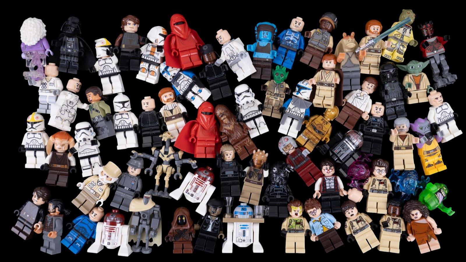 LEGO Star Wars and Ghostbusters Minifigures: LEGO Plastic minifigures inspired by Star Wars and Ghostbusters franchises. Includes a variety of characters wearing printed and detailed outfits resembling characters from both series.