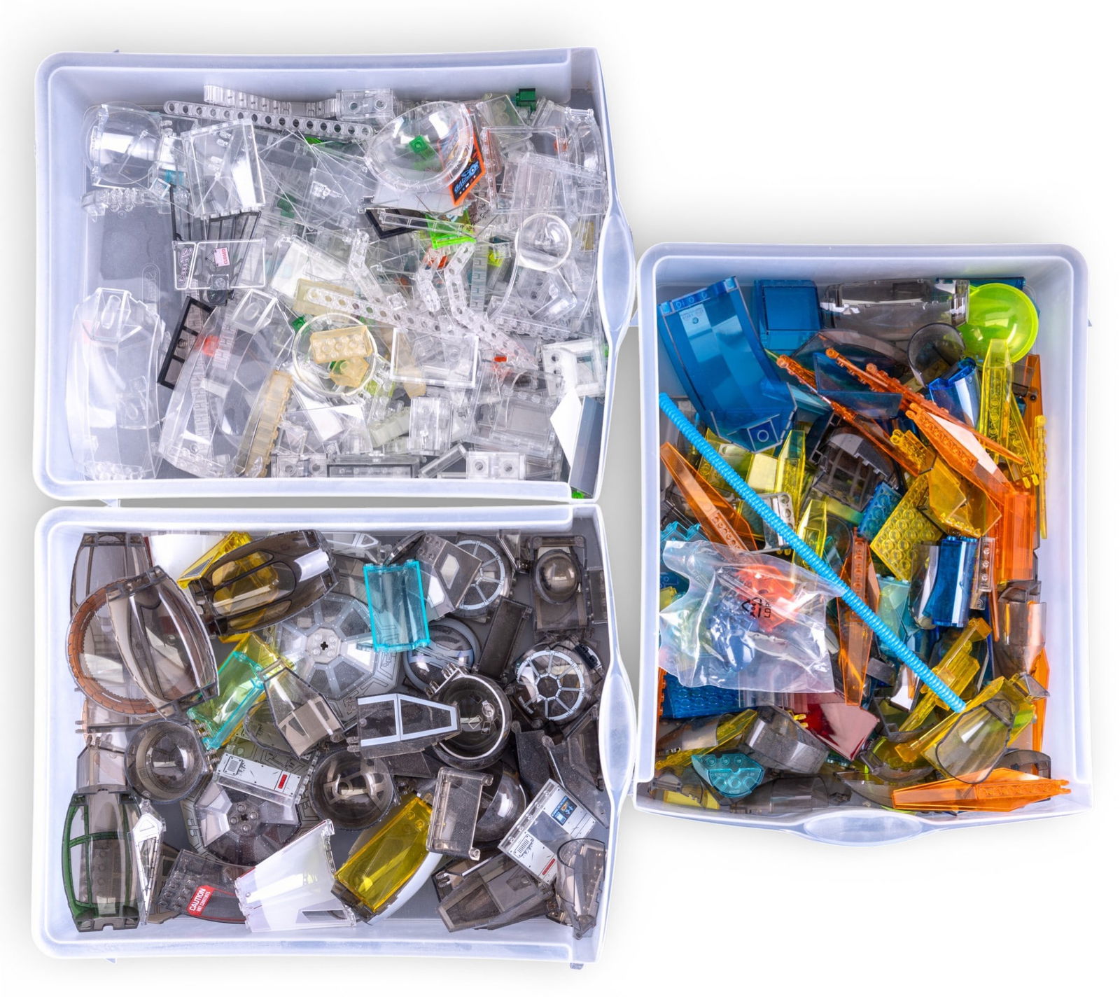 Loose LEGO Pieces with Opened 6099 Box: Loose LEGO building pieces including various clear, translucent, and themed components stored in plastic drawers. Includes an opened, empty box for the LEGO System Traitor Transport set 6099 and