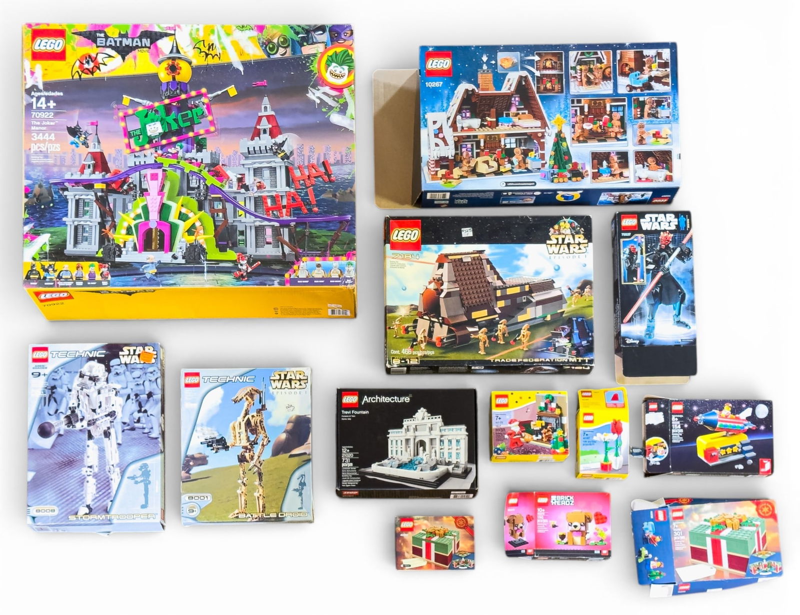LEGO Boxes with Instruction Booklets: Collection includes empty LEGO set boxes and some instruction booklets. Sets feature themes such as Batman, Star Wars, Creator Expert, and Architecture. Notable set numbers include 70922, 7194, and 10