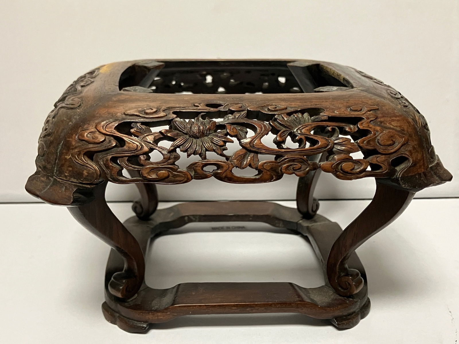 Chinese Carved Small Wood Stand: Finely carved with flowers Chinese wood footed planter stand approx 6" x 7" x 4" H.