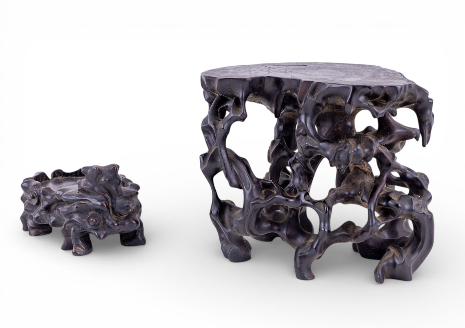 Early Chinese Carved Hardwood Stands (2 Pc): Two early hardwood carved Chinese stands measuring approx. 8.25" high and 4" high respectively. Smaller of the two in great condition,. larger has some cracks and damage to base as seen in