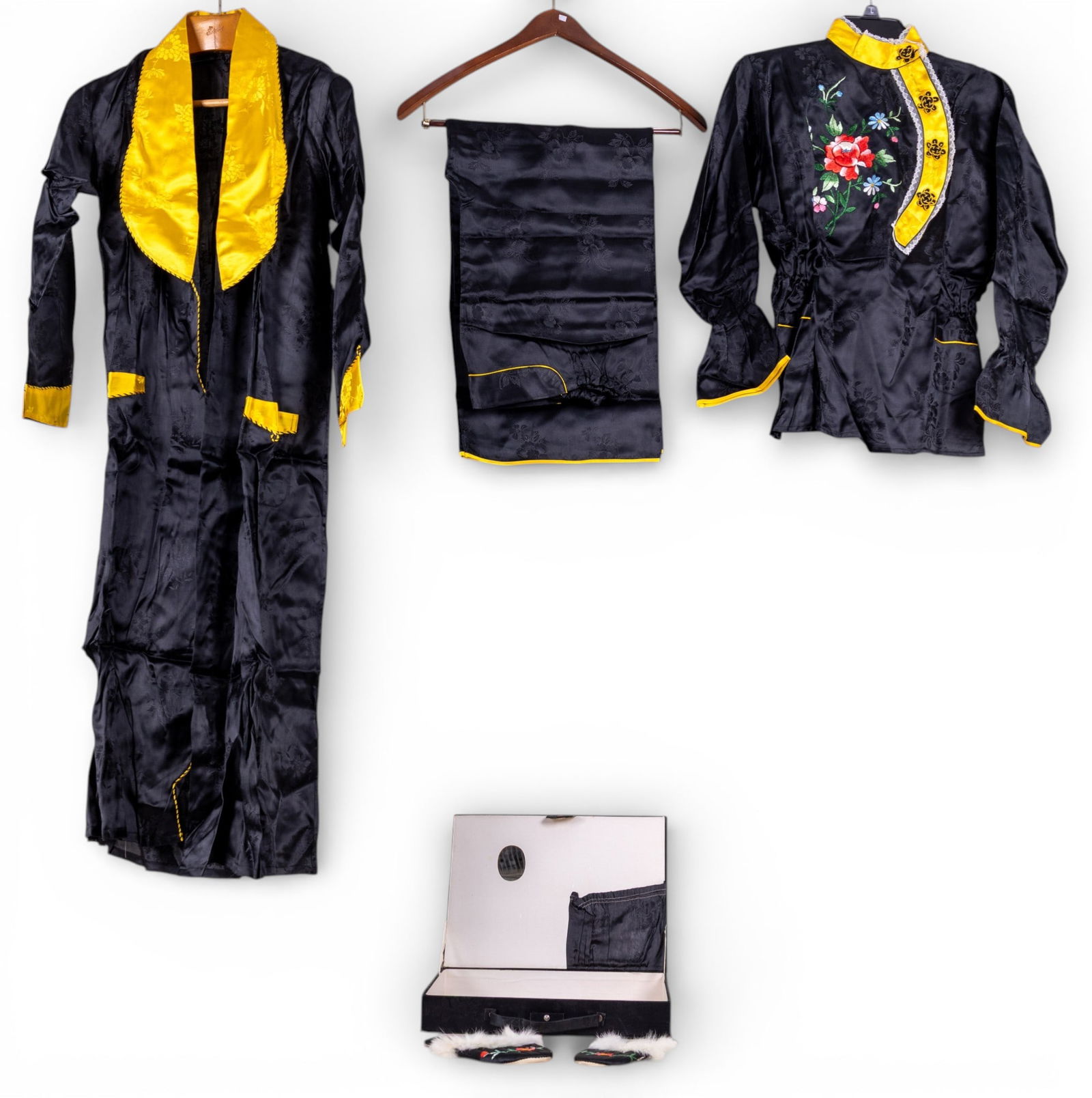 Chinese Pajama Set Silk w/ Slippers, Box: A Chinese silk polyester blend pajamas set including flower patterned pants, silk slippers with fur accents, a rose embroidered shirt, and a robe. and the original box. Black with gold / yellow trim.