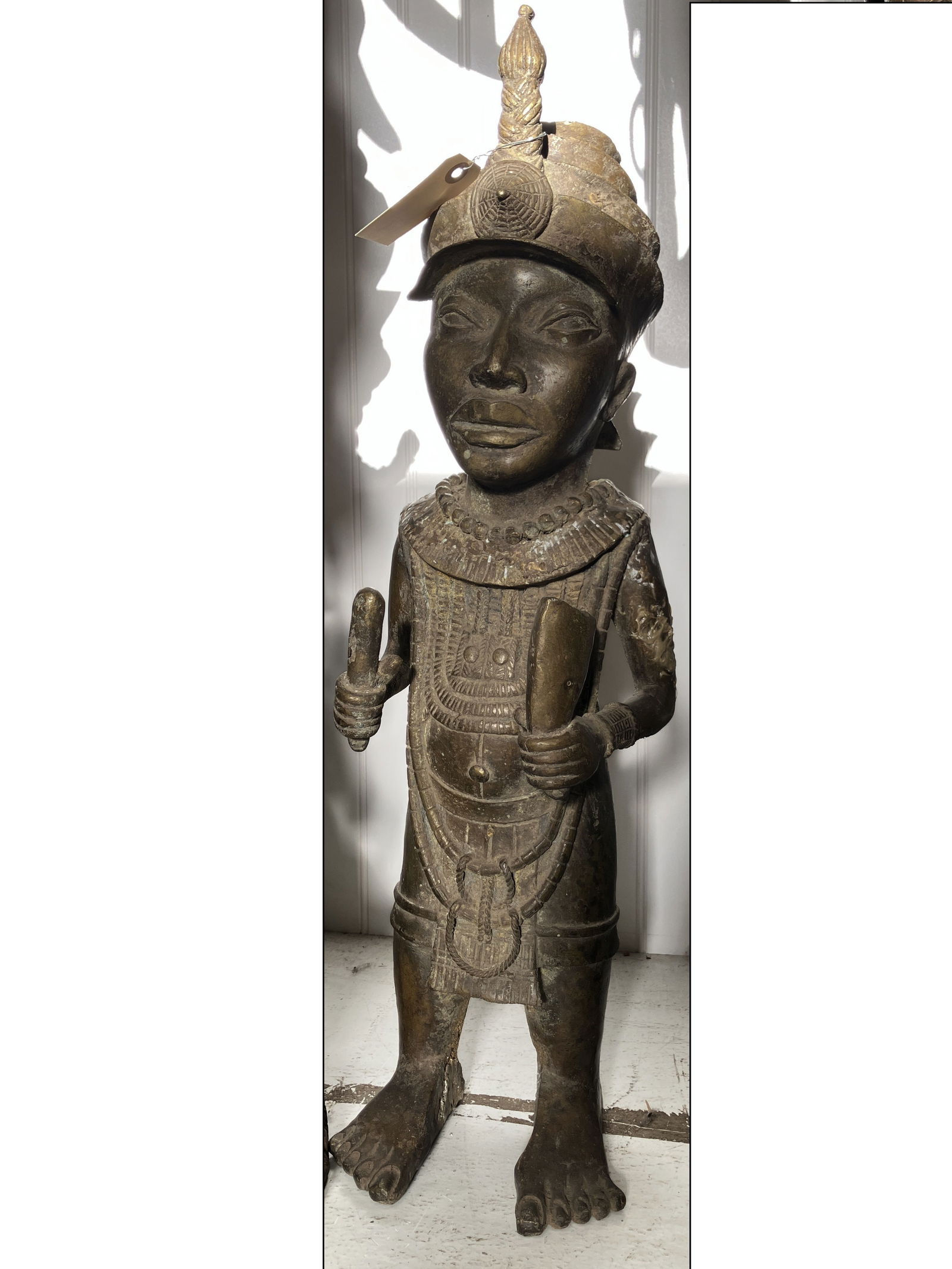 Benin Bronze Statuette w/ Instrument: Benin bronze statue likely depicting the Ona (king), possibly made in the town of Ife of the Benin and Yoruba people, measures approx. 8" W x 6" D x 26" H.