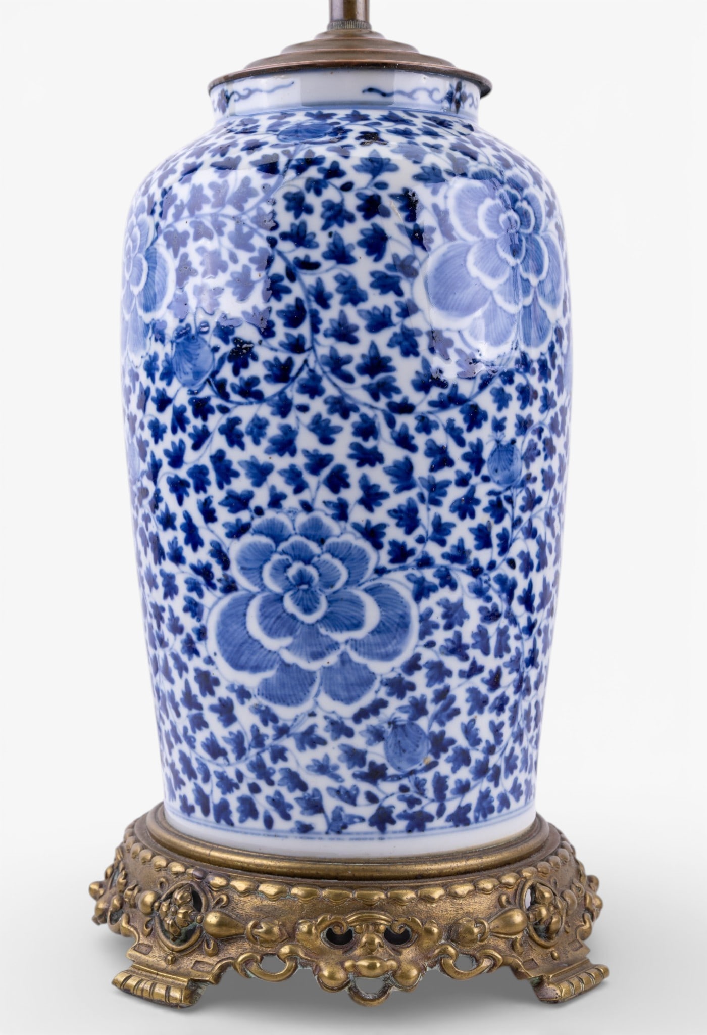 Chinese Blue and White Porcelain Lamp After Qing: A vintage Chinese blue and white floral porcelain lamp featuring an ornate brass footed base and two light sockets, after Qing, untested, measures approx. 22" H to the socket, 27" to the finial.