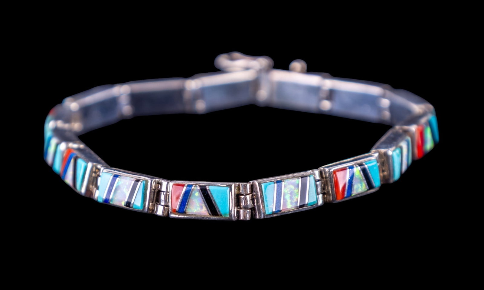 Inlaid Vintage Native American Bracelet: Sterling Silver Native American panel bracelet, inlaid with turquoise, coral, opal, lapis and intricate onyx detail. Total weight is approx. .5ozt.
