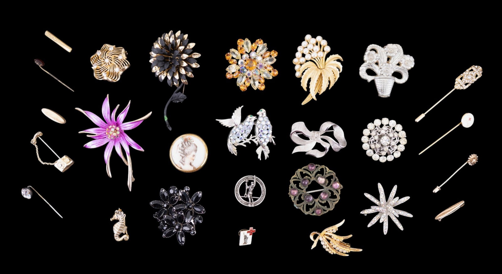 Rhinestone and Other Brooches: A collection of brooches featuring design elements such as rhinestones, porcelain, damask, and lucite, including brands such as Lisa, Lisner, and Avon.