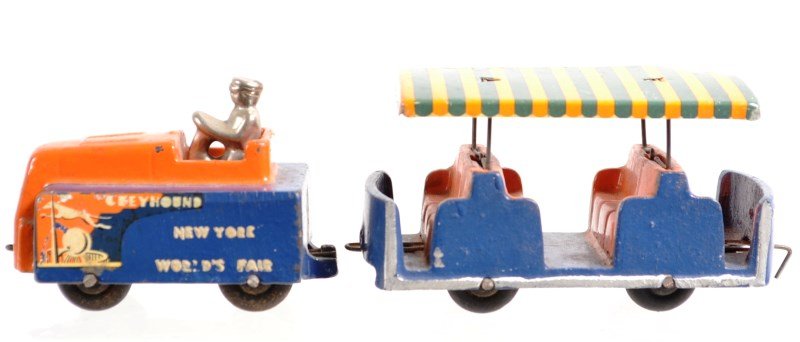 1939 World's Fair Cast Iron People Mover by Arcade: 1939 World's Fair cast iron people mover in original blue and orange paint; marked "Greyhound New York World's Fair"; made by Arcade, engine measures 2.25"h x 3.5"l x 1.75"l, people mover measures 2"h