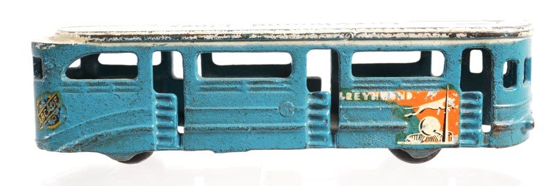 1939 World's Fair Cast Iron Greyhound bus: Arcade crafted Greyhound bus with original white, blue and orange paint; decals are intact, wheels and axels are sound; measures 6.75"l x 2"h x 1.5"w