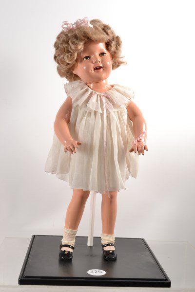 Ideal Flirty-eyed Shirley Temple Doll: Standing 27" tall, little bit of wear in leg joints, small scratch on cheek; otherwise in excellent condition with original clothes, working "flirty" eyes, mohair curls, upper teeth, dimples, and pain
