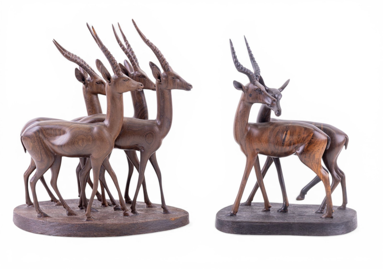 2 Signed Carved Wood Antelope Figurines: Pair of high quality carved wood antelope figurines, both signed on the bottom, one reads "Kisinga". Tallest piece measures approx. 10.5" H. Very good condition.