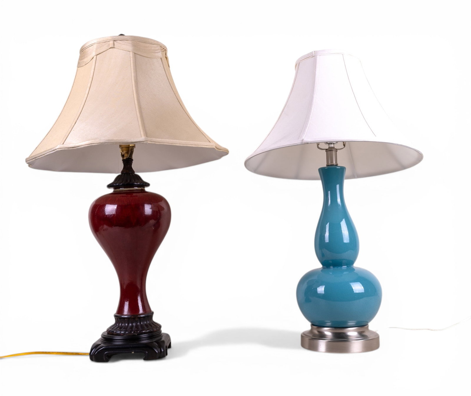 2 Mid-Century Style Bulbous Table Lamps: Two Mid Century style table lamps featuring ceramic bodies. One example with a deep red glaze and classic baluster form on a stepped base; the other with a teal glazed double-gourd form mounted on a b