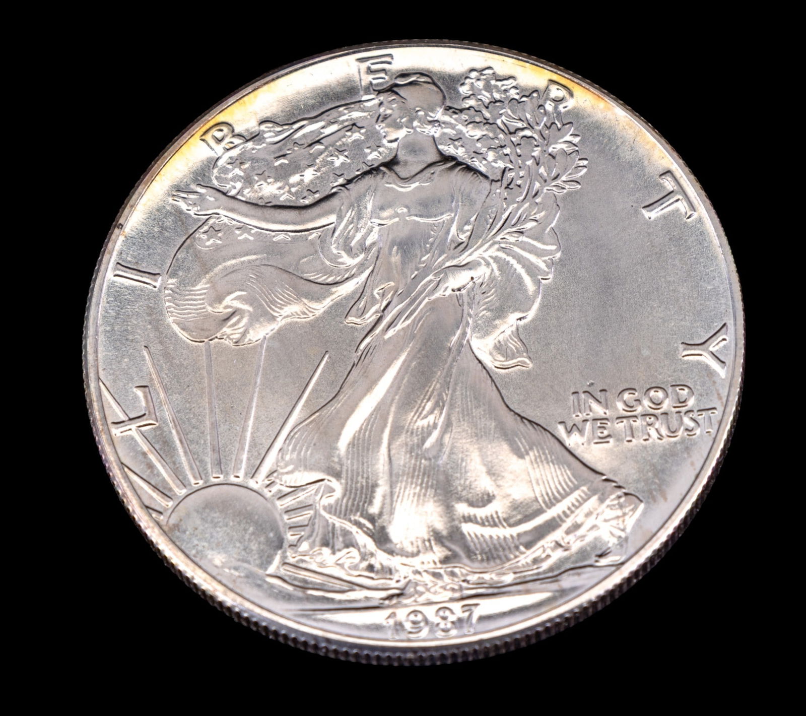 2017 American Silver Eagle Bullion Coin: 2017 American Silver Eagle coin composed of 1 troy ounce of .999 fine silver. Features the Walking Liberty design on the obverse and a heraldic eagle with shield on the reverse. Encased in a protectiv