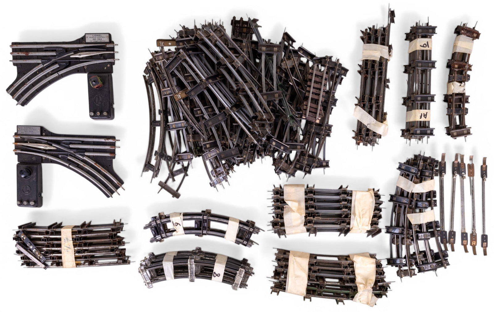 Lionel O Gauge No. 022 Remote Switches, Track: Vintage Lionel O gauge components including 2 No. 022 remote control switches and a large quantity of track sections. Tub of track weighs approx. 17 pounds.